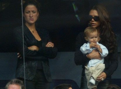 Rebecca Loos with Victoria Beckham, holding her son Romeo, at a Real Madrid match against Valladolid at the Santiago Bernabéu, on September 13, 2003 in Madrid.